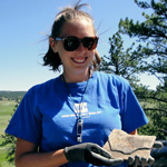 Image of student holding a fossil in the field