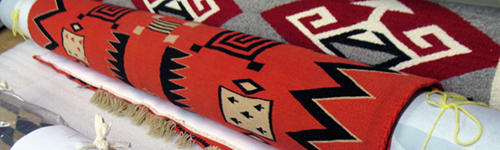 Image of Navajo rugs rolled for storage