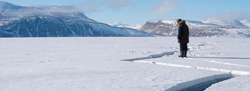 Photo of Inuit observing crack in sea ice