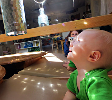 child looking at mirrored object