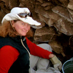 Image of female MFS student wearing a cowboy hat on archaeology dig