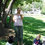 Image of MFS education student demonstrating atlatl to school group