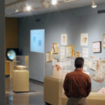 Thumbnail image of a student looking at exhibits in the BioLounge