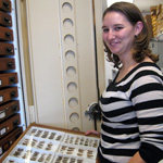 thumbnail image of Crystal Boyd holding a drawer of grasshopper specimens in the entomology collection