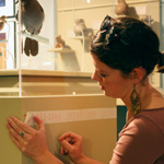 Thumbnail image of Rebecca Wahlberg working on an exhibit installation