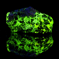 Image of rock fluorescing green under UV light