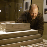 museum assistant director Jim Hakala looking at an architectural model in an exhibit