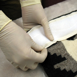 Image of hands repairing a Navajo rug