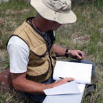 Image of entomology student writing in field notebook