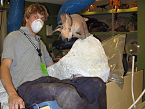 Image of John Hankla in paleontology prep lab, wearing a surgical mask