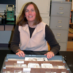 Image of Museum Associate with drawer of fossils