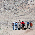 Image of paleontology students hikinh
