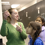 Image of MFS student showing an education collection specimen to middle schoolers